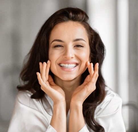 Woman showing bright and natural looking teeth after cosmetic dentistry treatment in Carthage