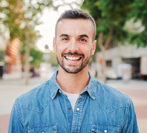 Patient smiling after restorative dentistry treatment in Carthage