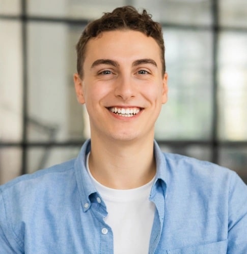Smiling man with bright white teeth after professional teeth whitening treatment in Carthage